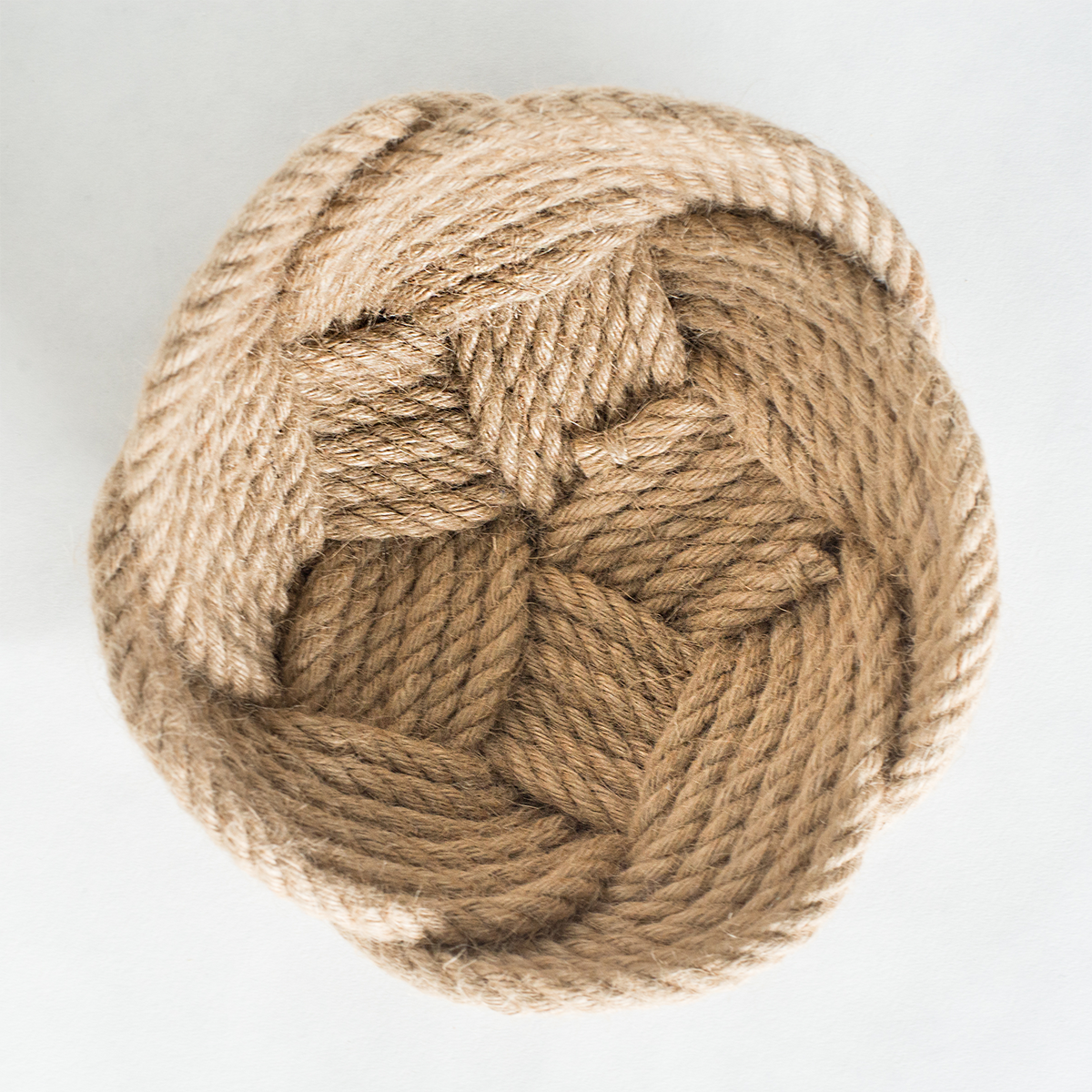 Woven natural jute rope mat on white background, KTL travel safety accessory